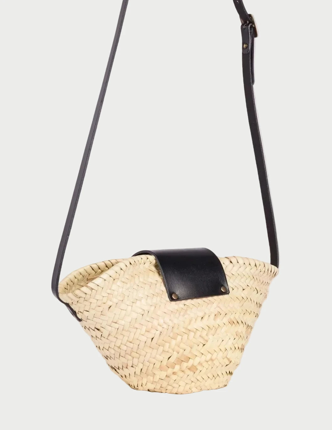 Back view of the Dija Crossbody palm leaf basket bag showing the woven doum palm