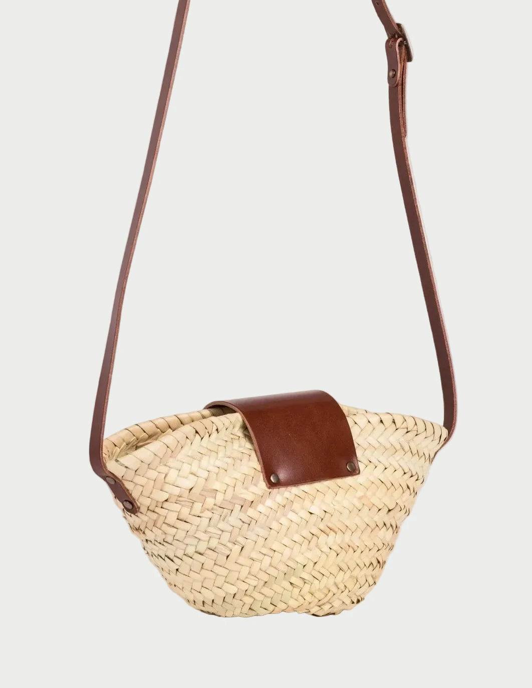 Back view of the Dija Crossbody palm leaf basket bag showing the woven doum palm