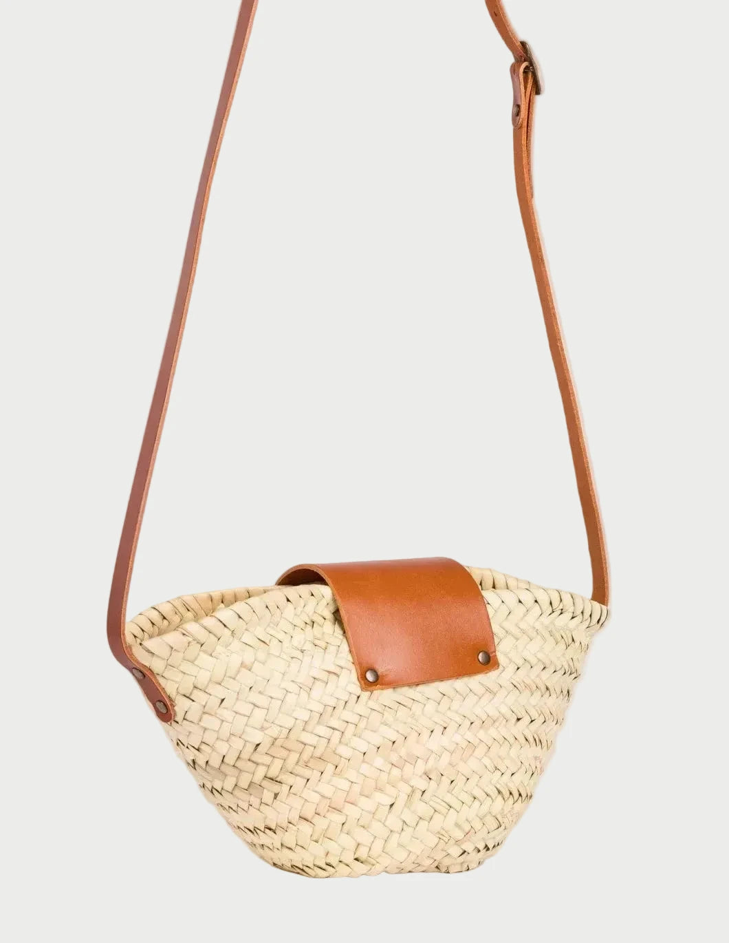 Back view of the Dija Crossbody palm leaf basket bag showing the woven doum palm