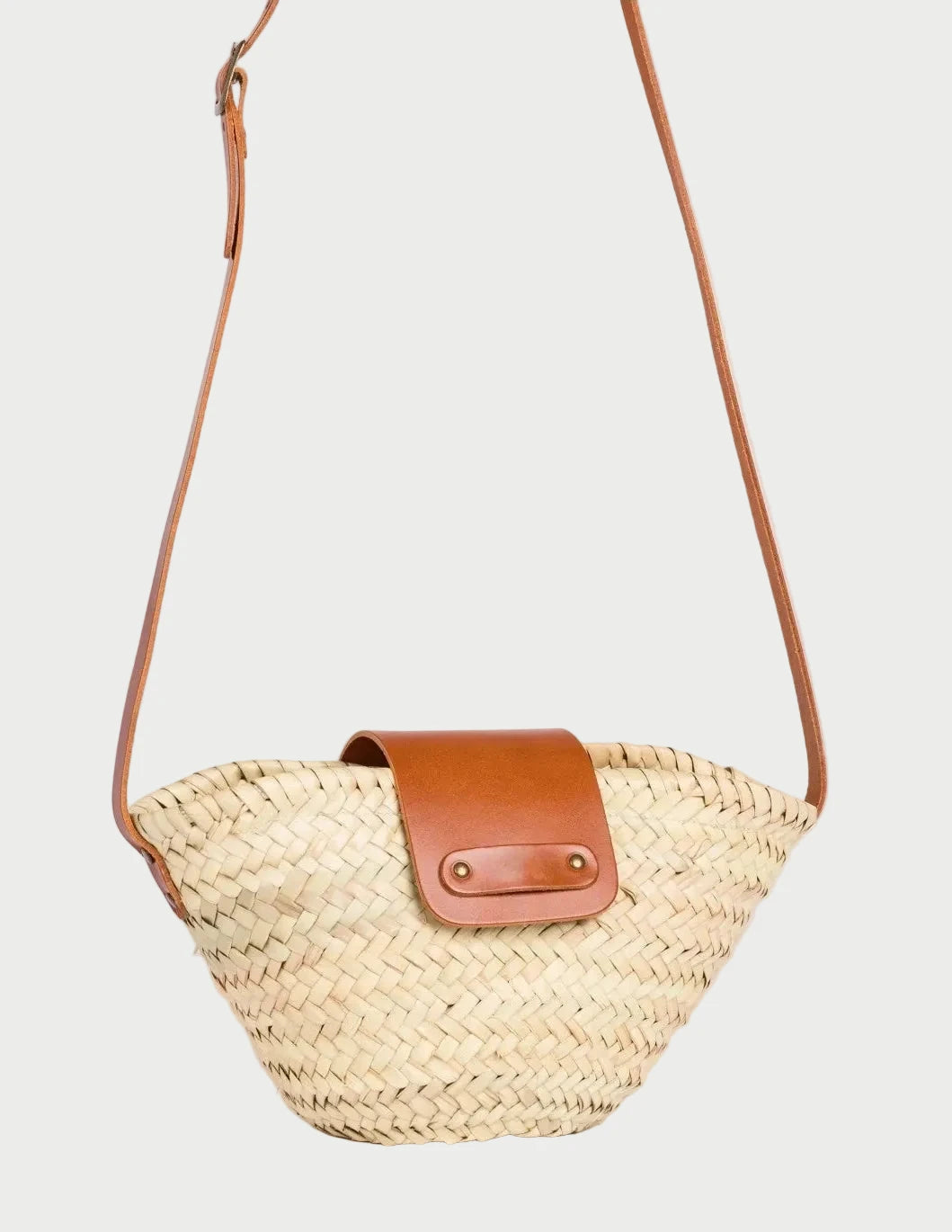Side view of the Dija Crossbody basket bag in palm leaf with light brown calfskin