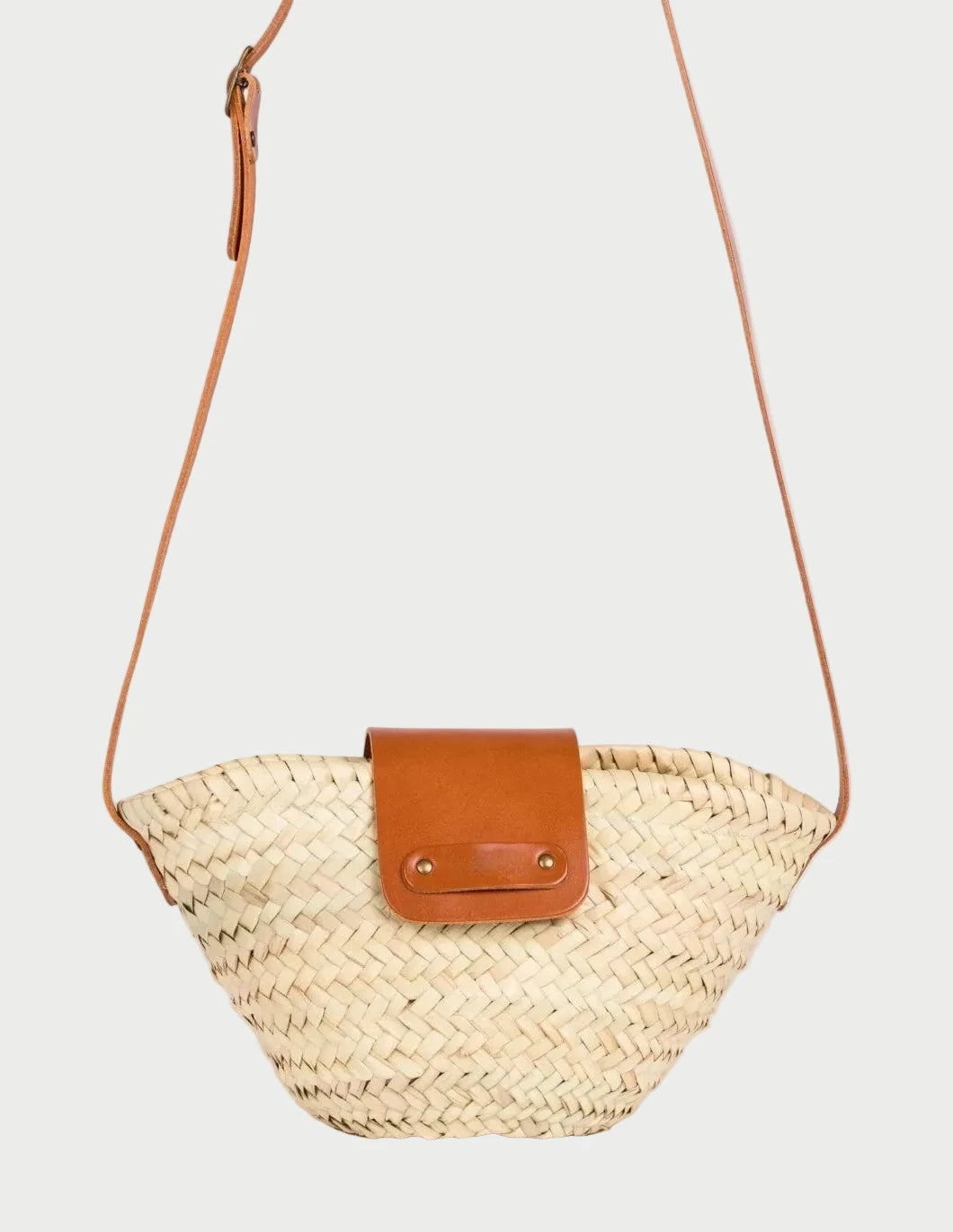 view of the Dija Crossbody palm leaf basket bag with light brown calfskin