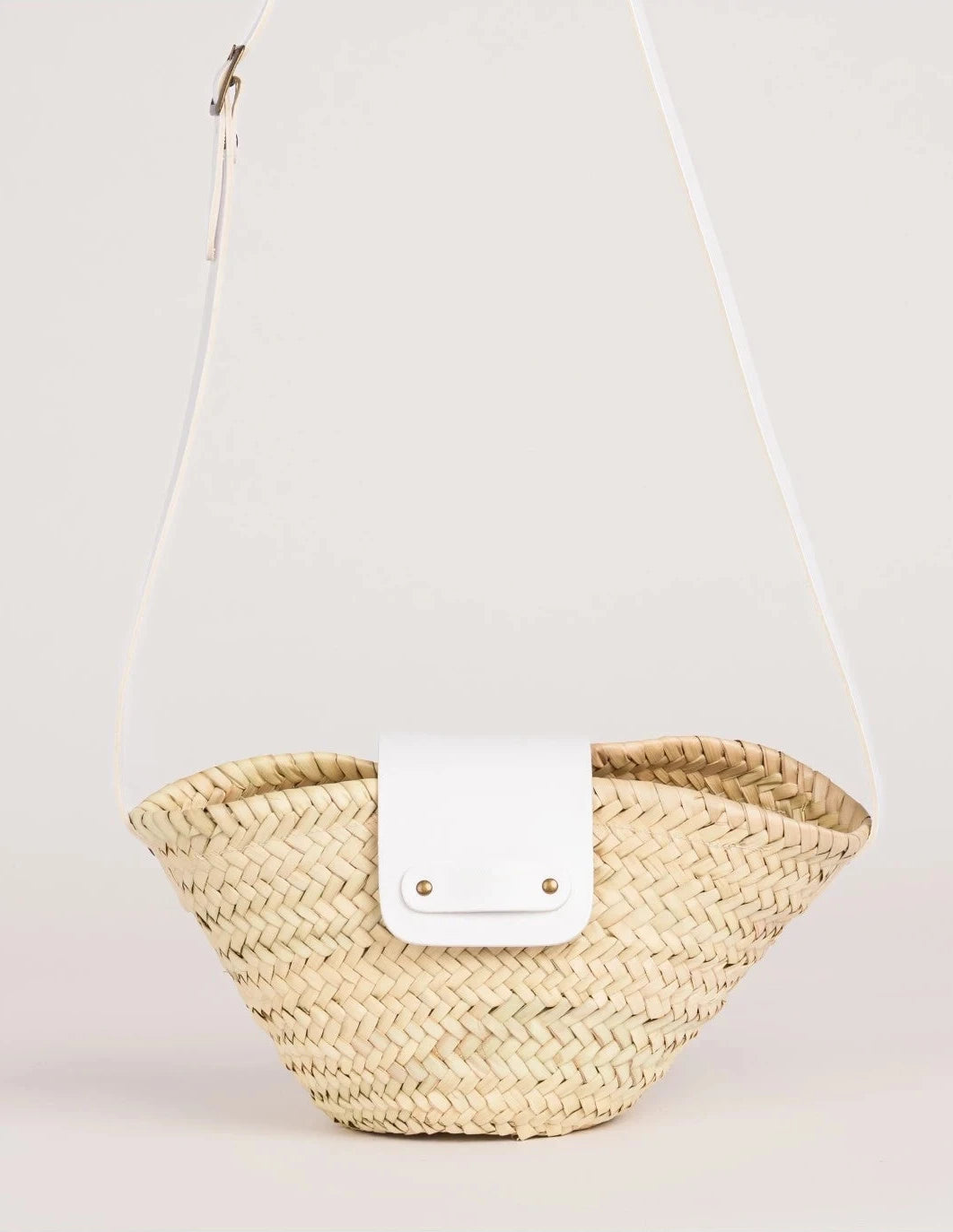 Dija Crossbody palm leaf basket bag with white calfskin strap and flap, front view closeup