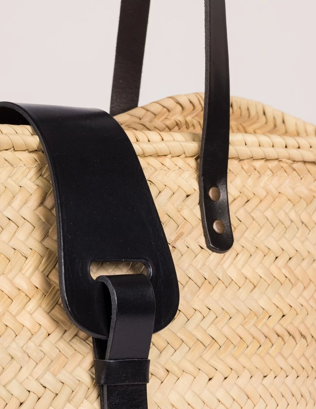 Close-up of the black calfskin front strap and trim on the Fadma Large