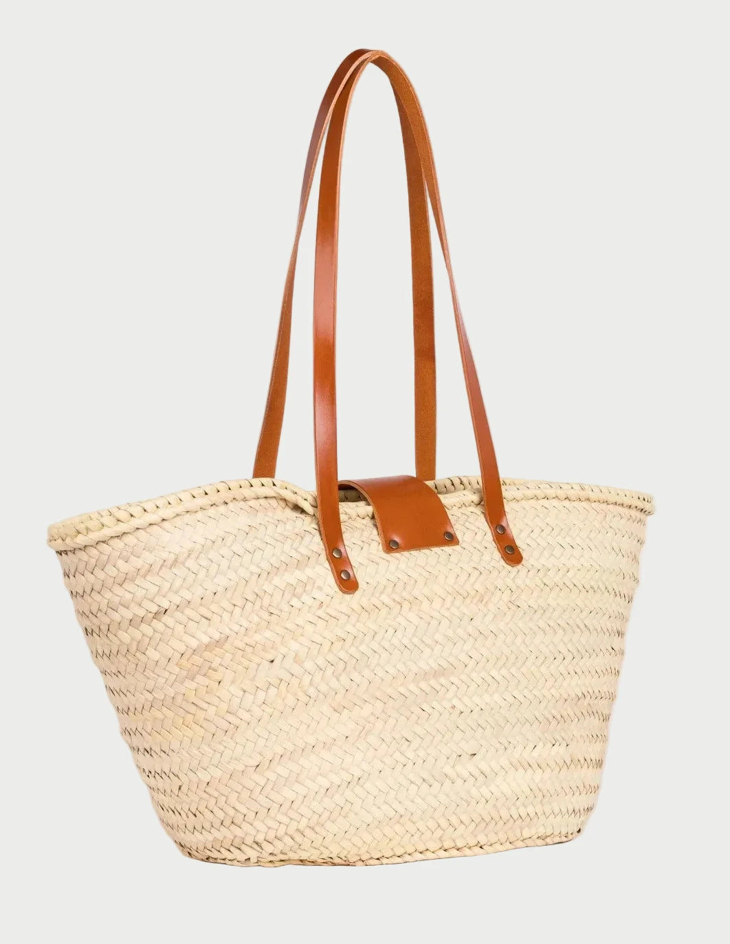 Back view of the Fadma Large palm leaf basket bag showing the woven doum palm and light brown calfskin straps