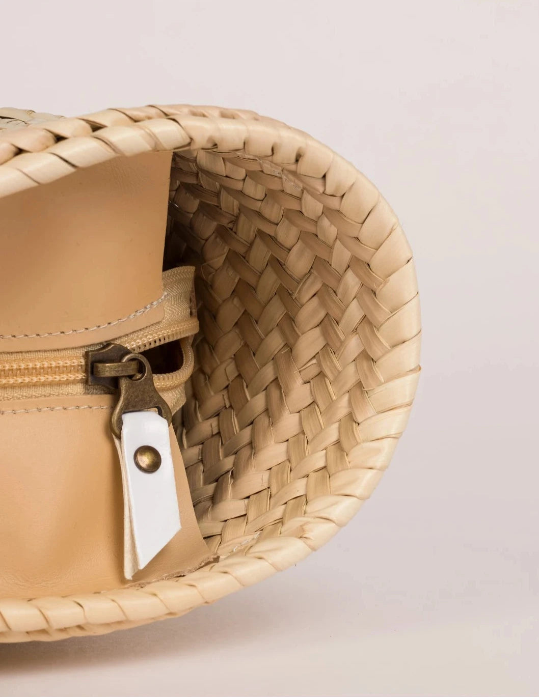 Side view of the Fadma Small basket bag in palm leaf