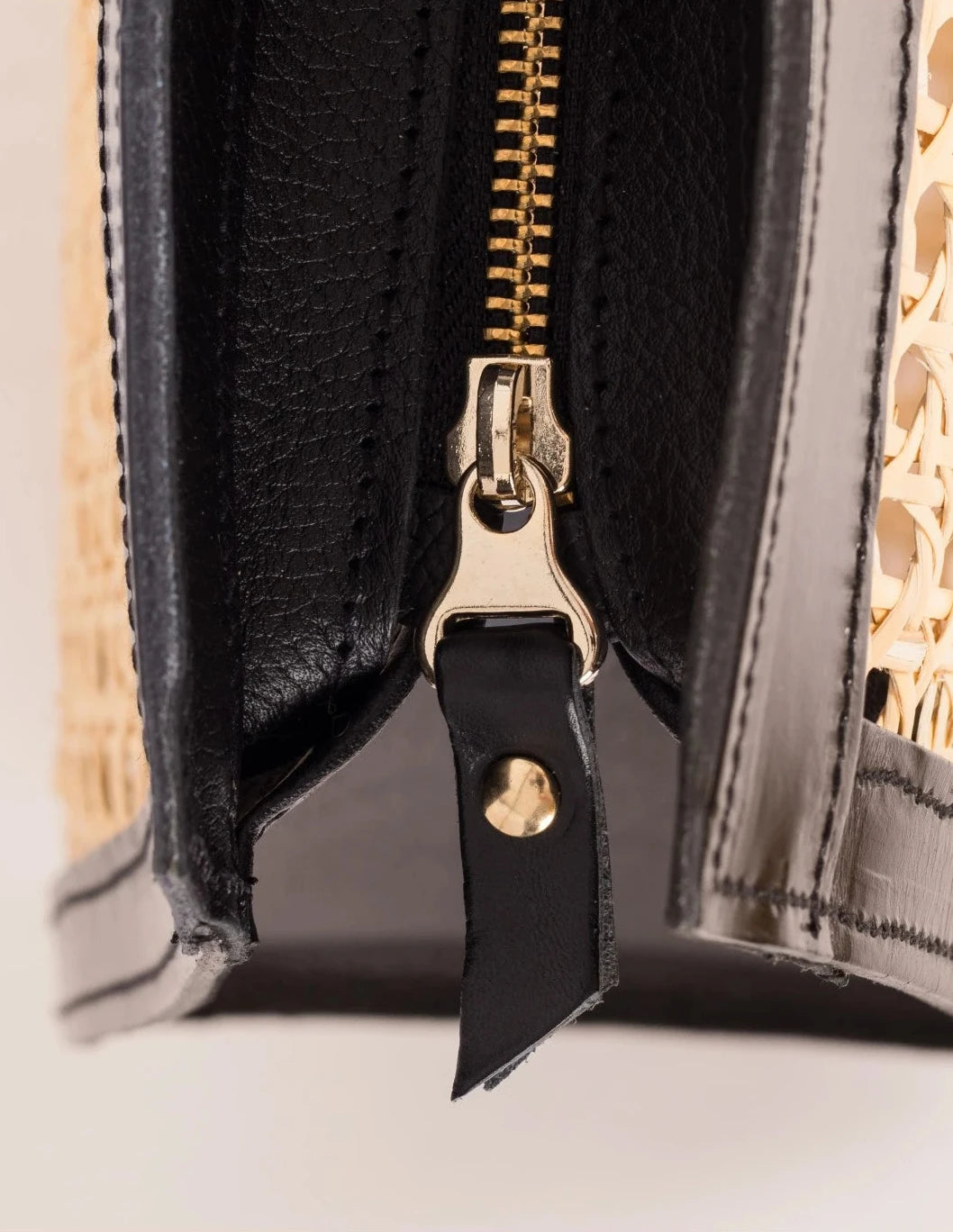 Close-up of the YKK zip closure with leather gussets on the Lamia Cane Tote