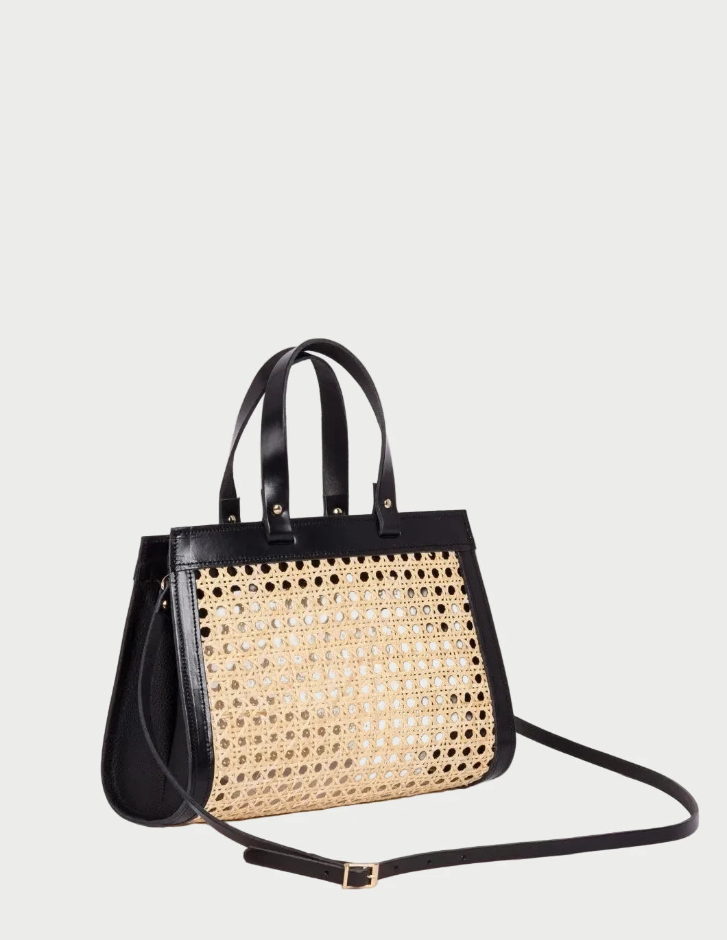 Lamia Mini rattan cane bag with black leather frame and shoulder strap, side angle