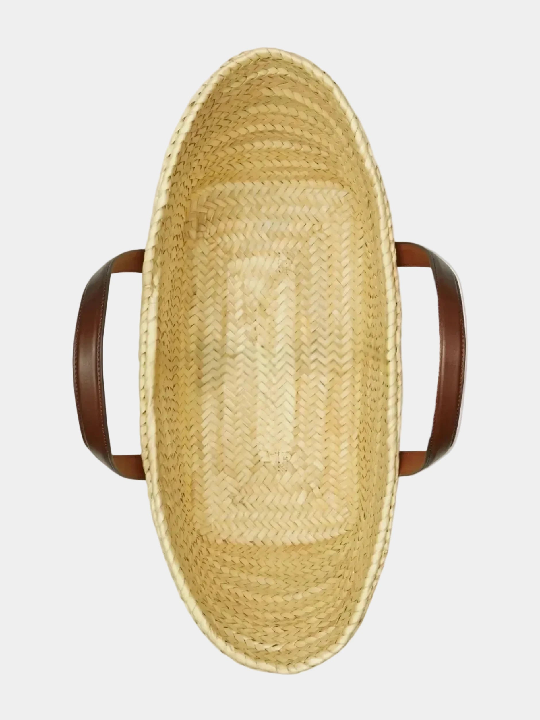 Top view of Malika basket tote showing open interior and handwoven palm base