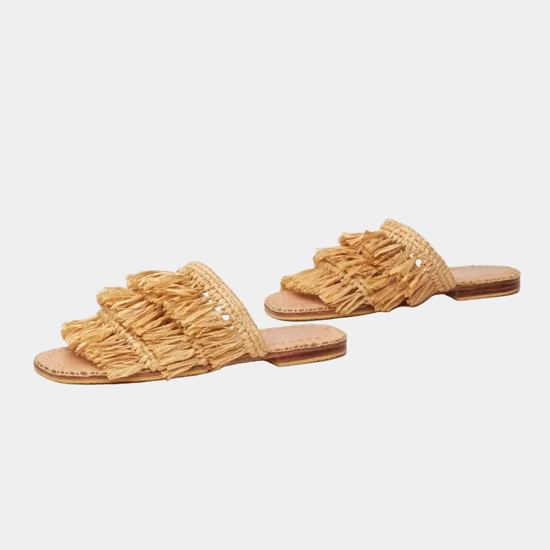Side profile of flat raffia fringe slide with veg-tanned leather sole — Silya sandal by MARRAVIE