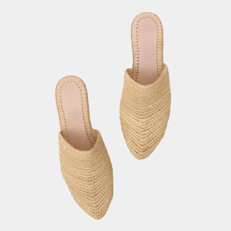 Pair of natural raffia babouche mules shown at an angle, handwoven texture detail — Tilila mule by MARRAVIE