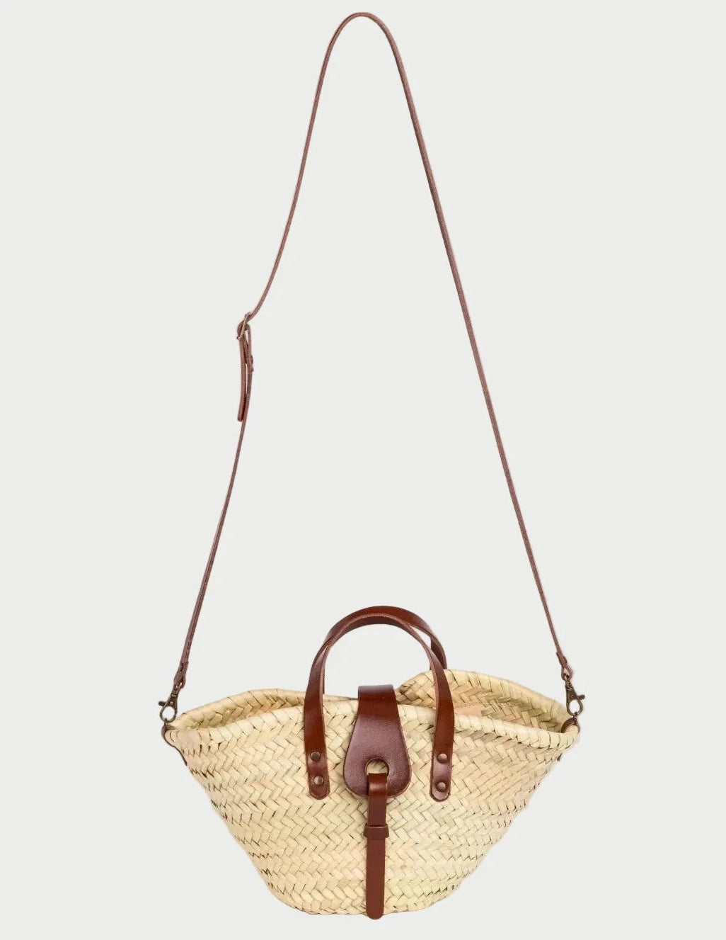 Zahira Mini handwoven palm leaf basket bag with dark brown calfskin top handles and shoulder strap