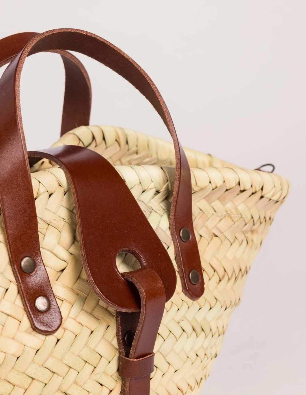 Zahira Mini handwoven palm leaf basket bag with dark brown calfskin top handles zoom shoot