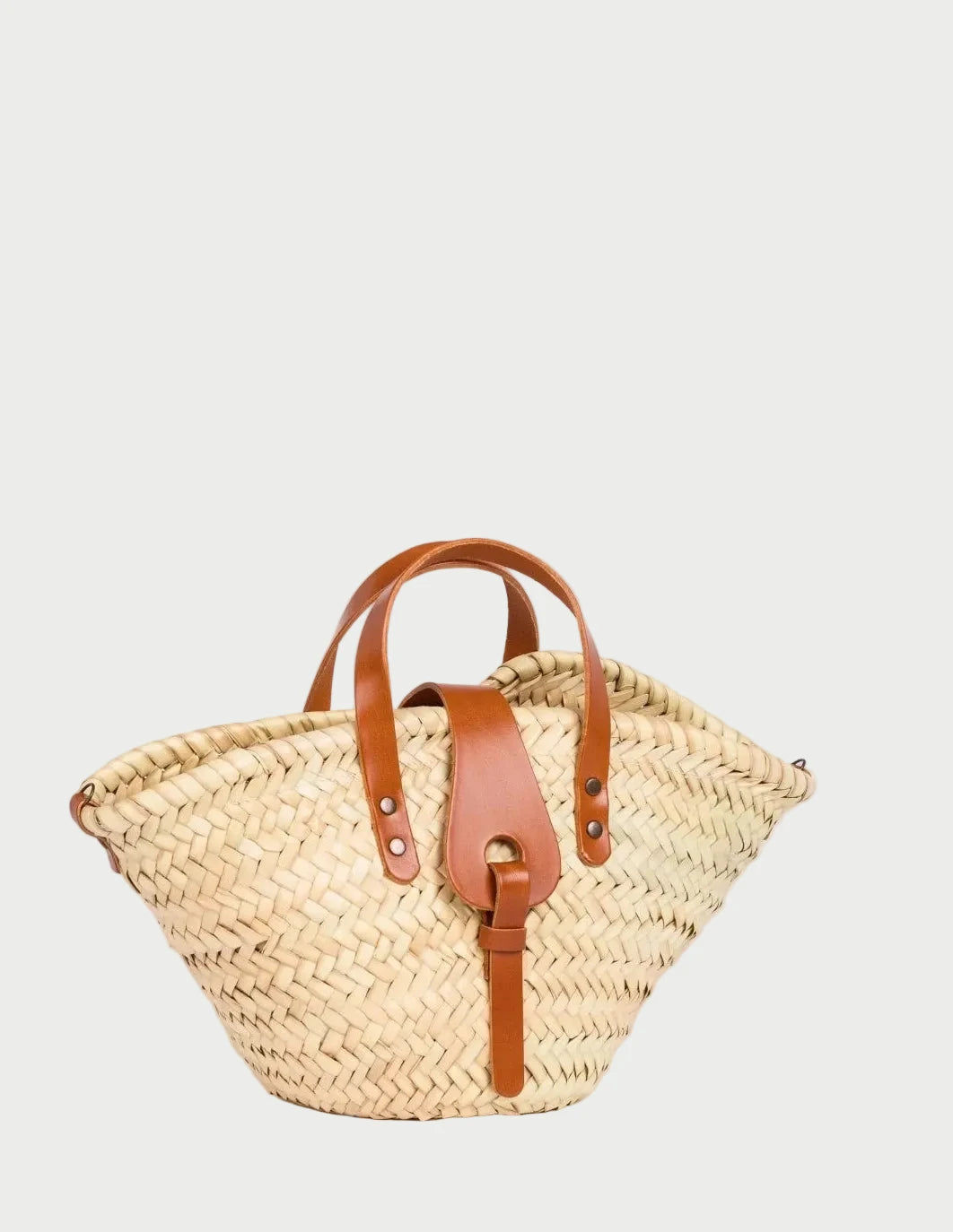 Zahira Mini handwoven palm leaf basket bag with light brown calfskin top handles.