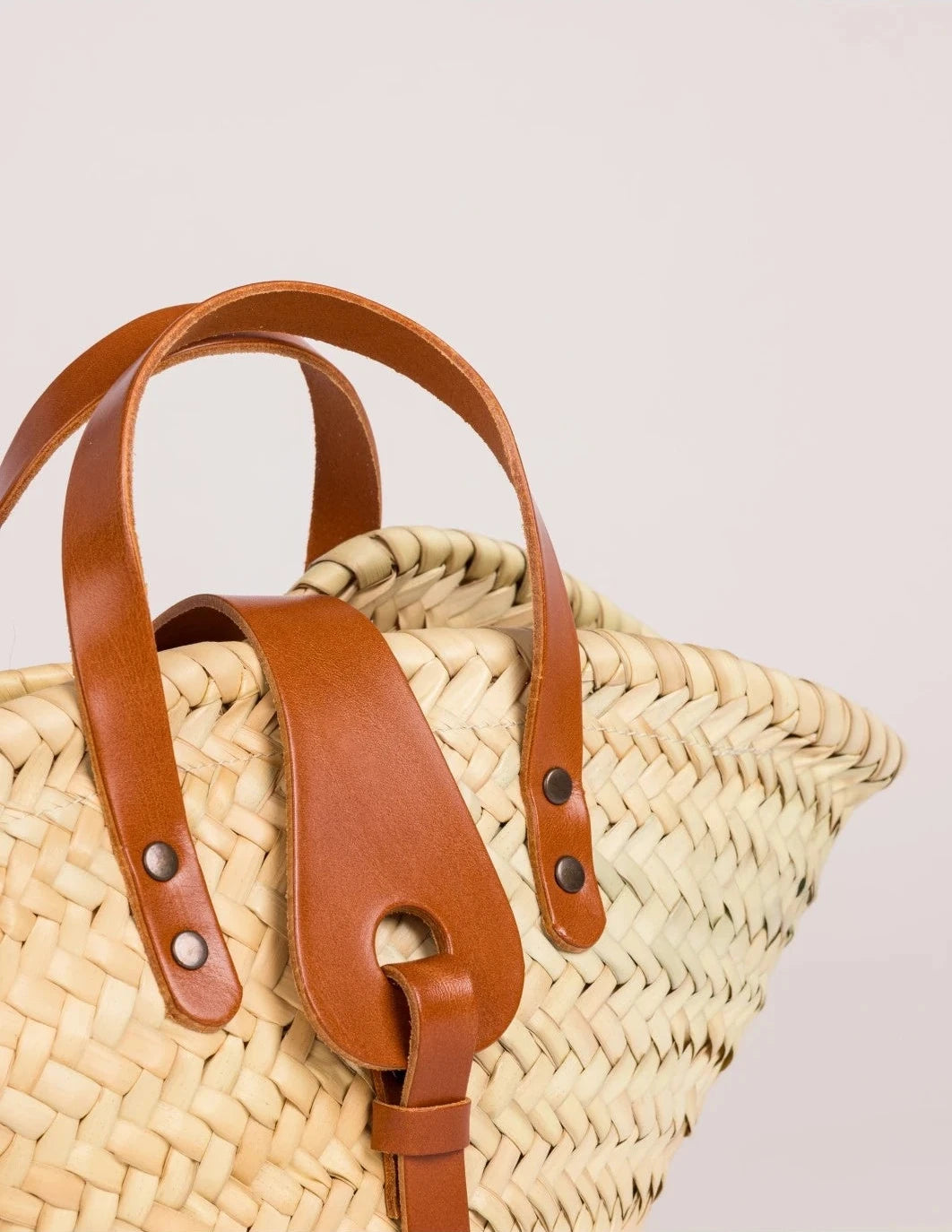 Zahira Mini handwoven palm leaf basket bag with light brown calfskin top handles closure shoot