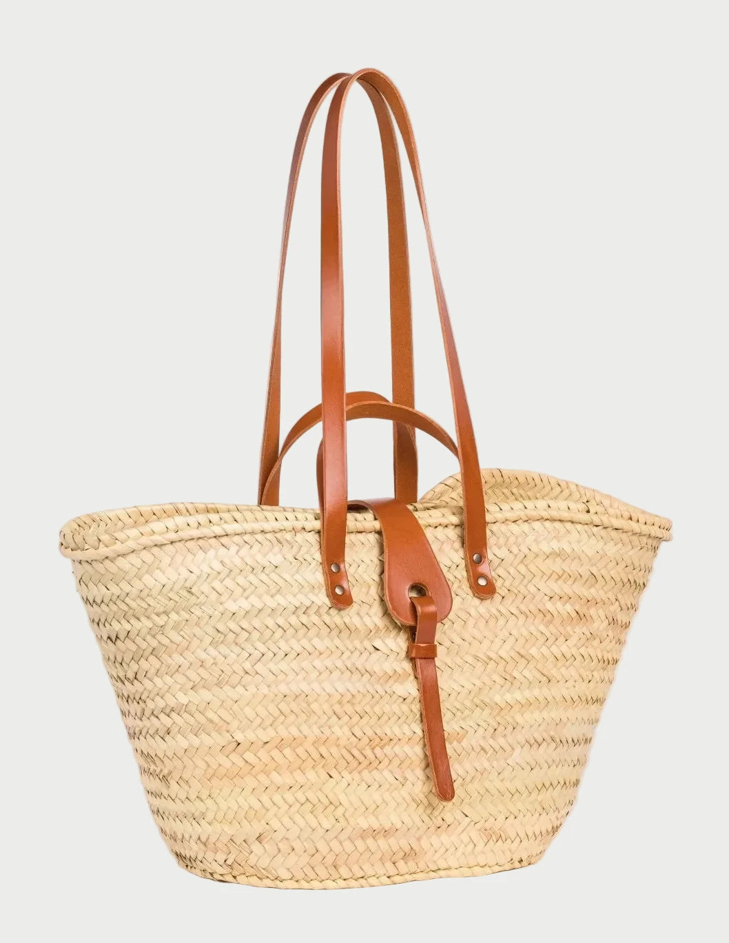 Side view of the Zhour Large basket bag in palm leaf with light brown calfskin straps
