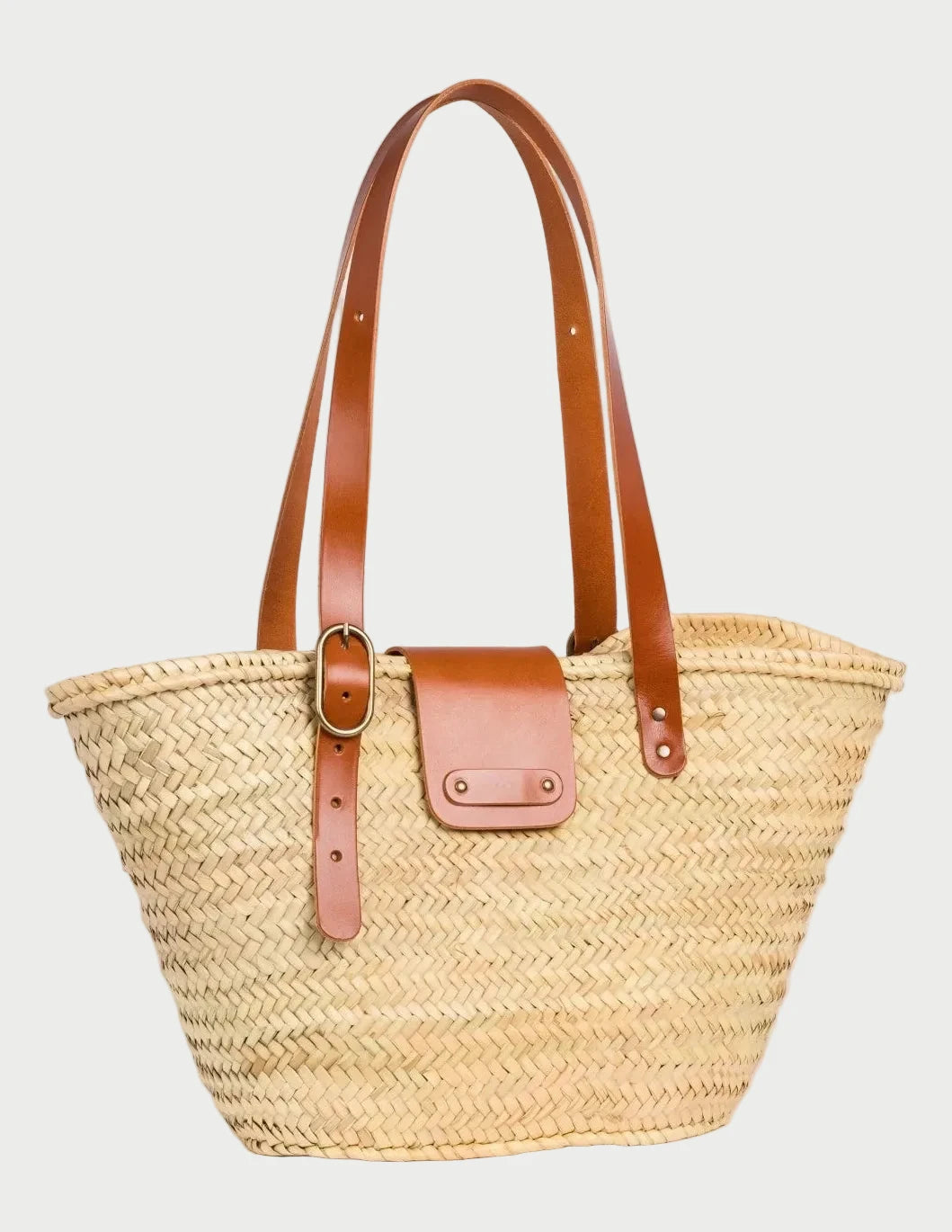 Angled view of Aicha handwoven palm leaf basket bag with light brown calfskin leather details