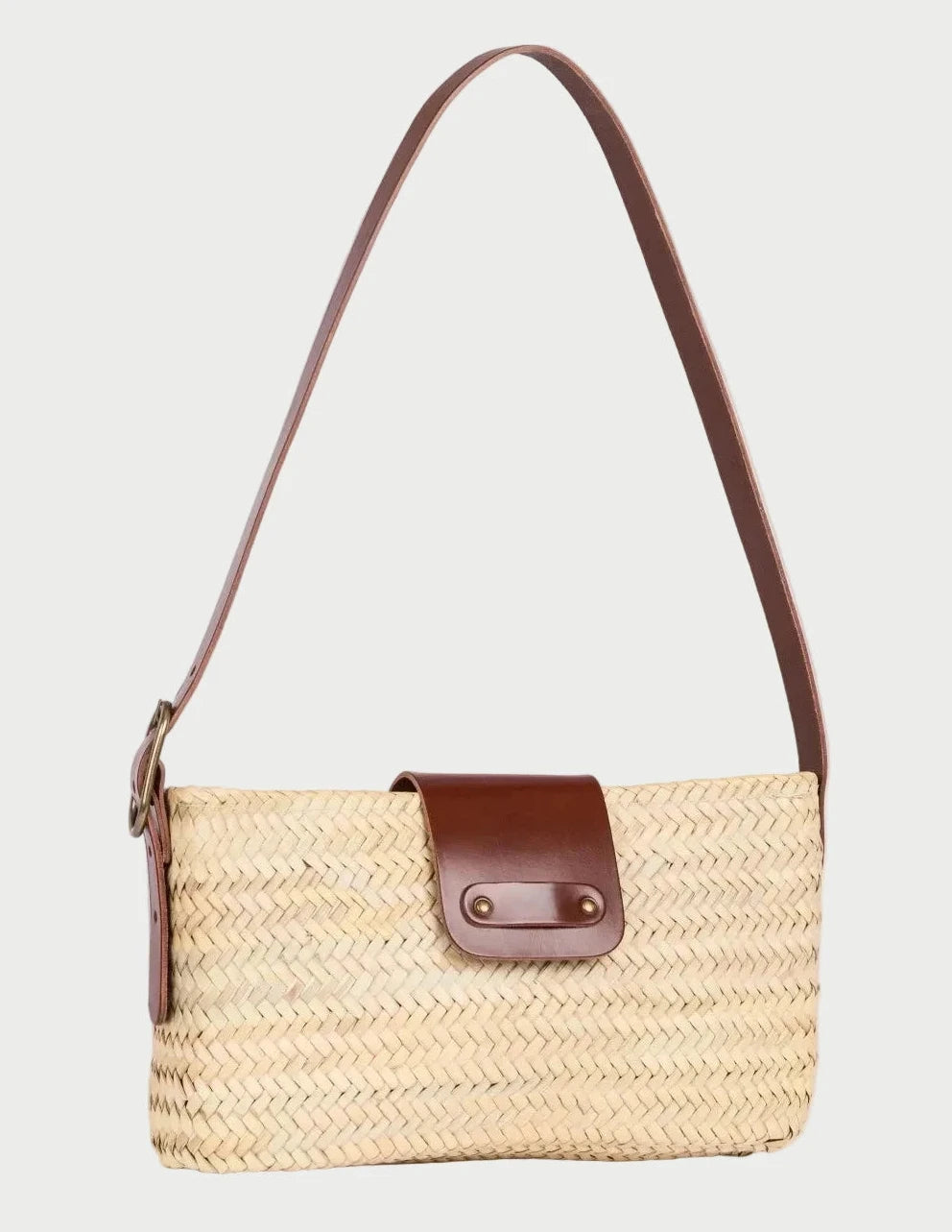 Asmae palm leaf baguette bag with dark brown calfskin trim, three-quarter angle