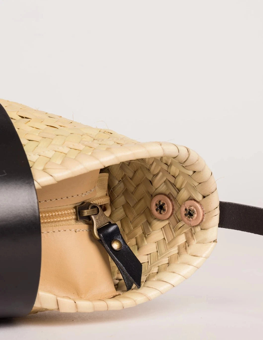 Inside view of the Dija Crossbody palm leaf basket bag with black calfskin lining