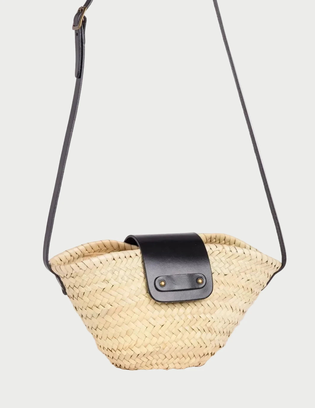 Side view of the Dija Crossbody basket bag in palm leaf with black calfskin