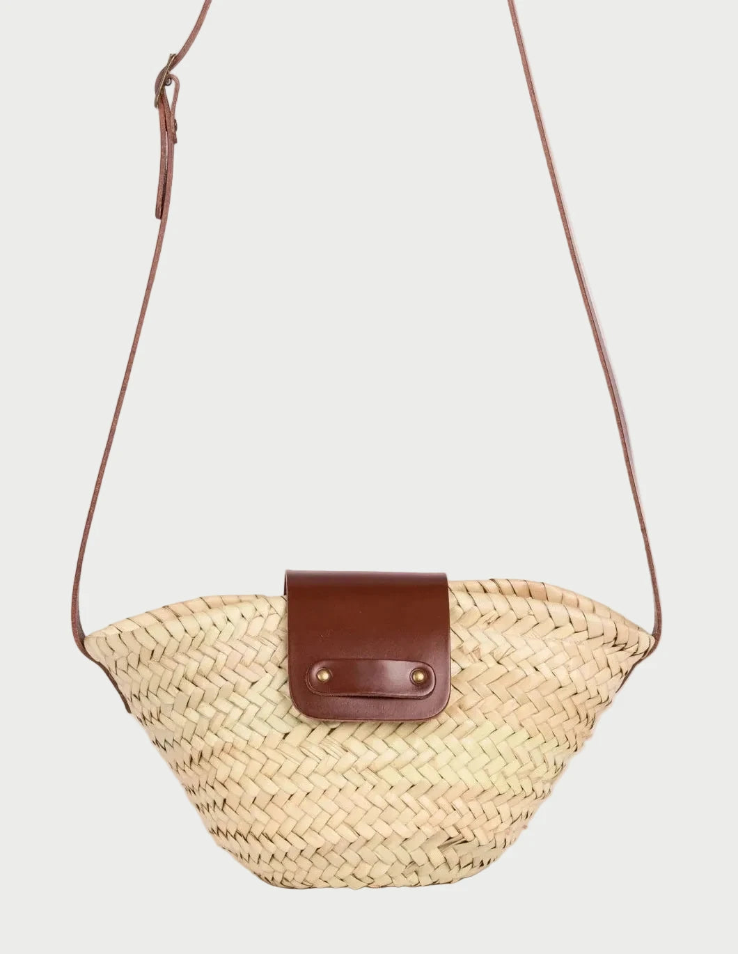 Dija Crossbody palm leaf basket bag with dark brown calfskin strap and flap, front closeup
