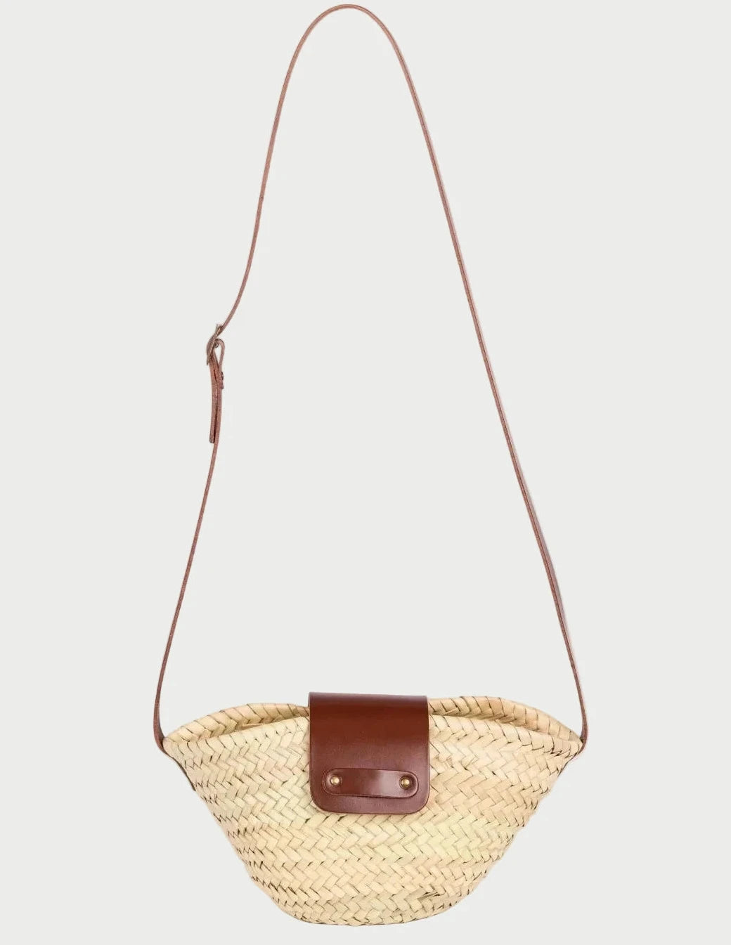 Dija Crossbody palm leaf basket bag with dark brown calfskin strap and flap, front view