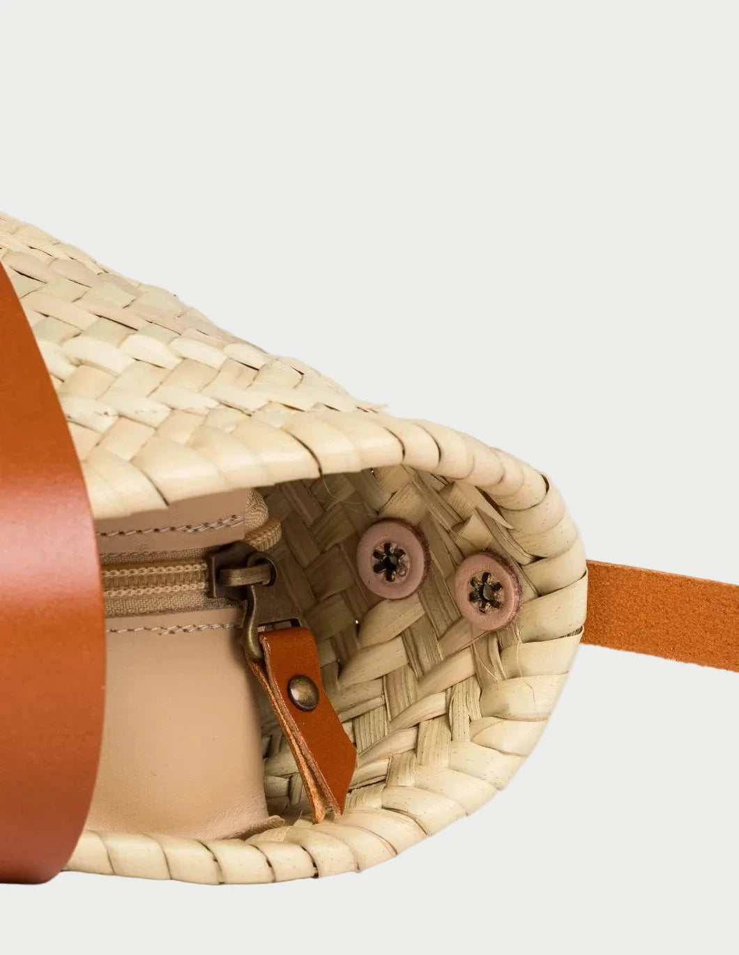 Inside view of the Dija Crossbody palm leaf basket bag with light brown calfskin lining