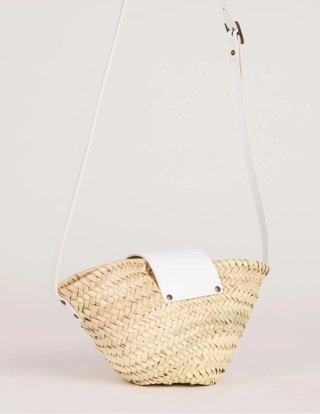 Back view of the Dija Crossbody palm leaf basket bag showing the woven doum palm
