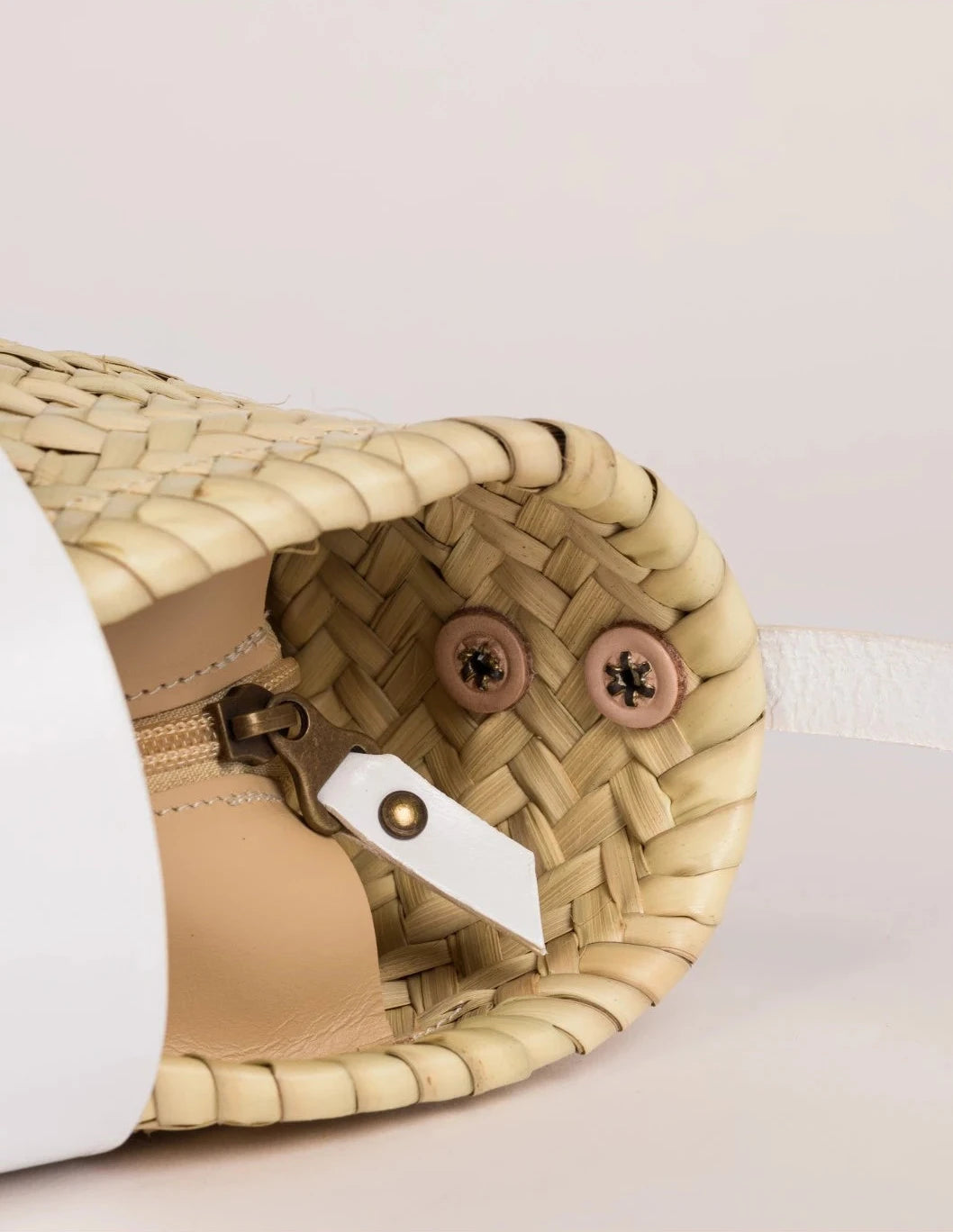 Inside view of the Dija Crossbody palm leaf basket bag with white calfskin lining