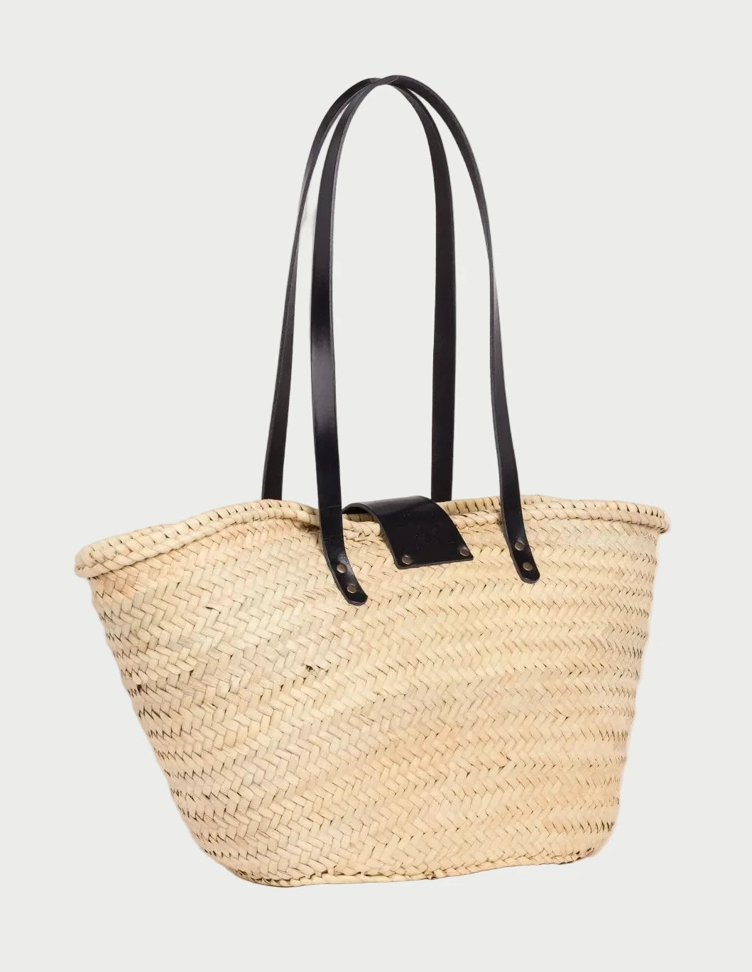 Back view of the Fadma Large palm leaf basket bag showing the woven doum palm and black calfskin straps