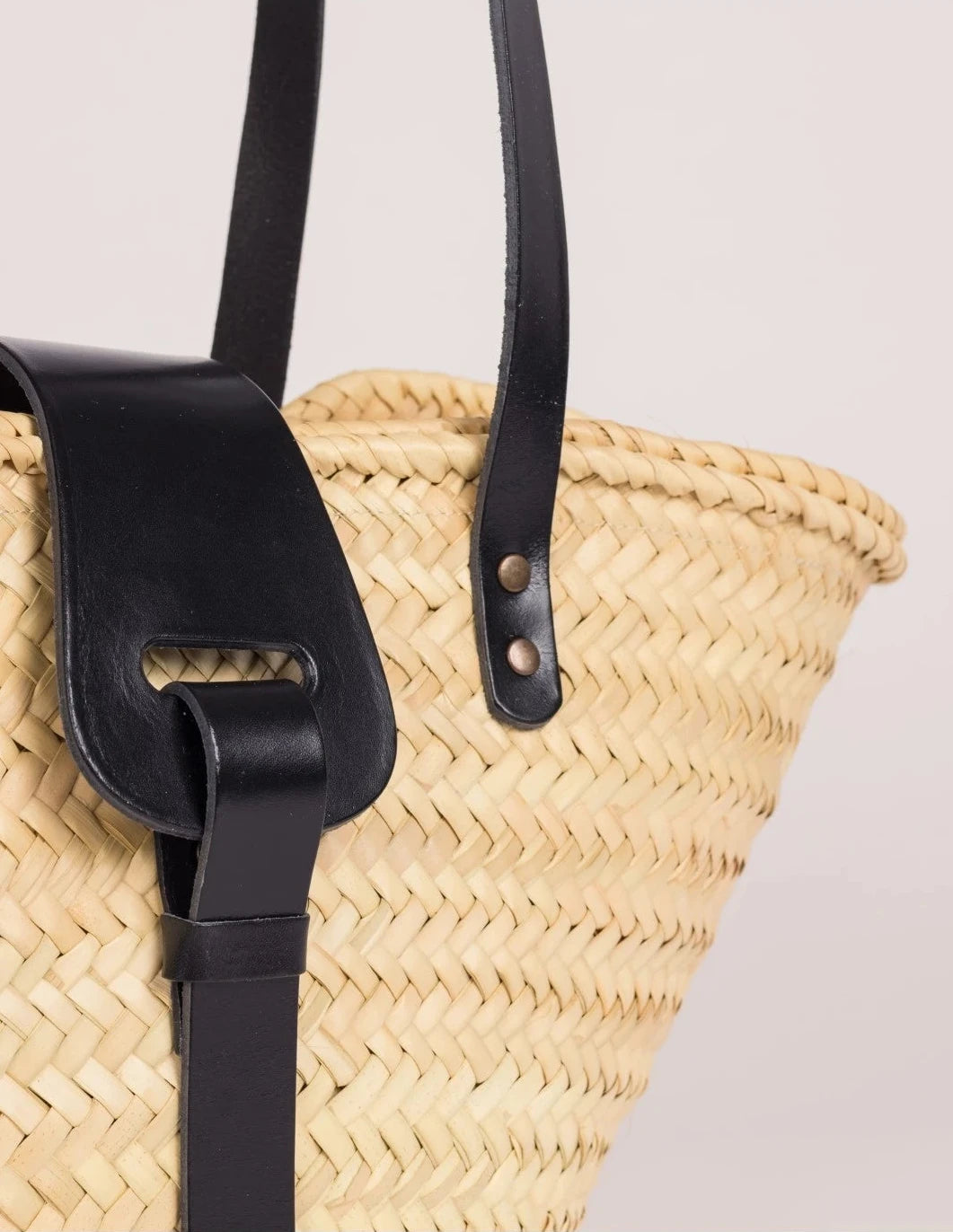 Close-up of the black calfskin front strap and trim on the Fadma Small