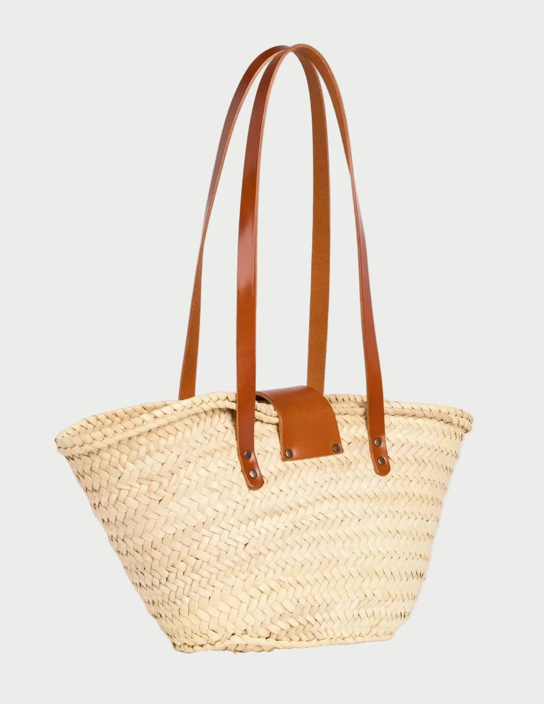 Back view of the Fadma Small palm leaf basket bag showing the woven doum palm and light brown calfskin straps
