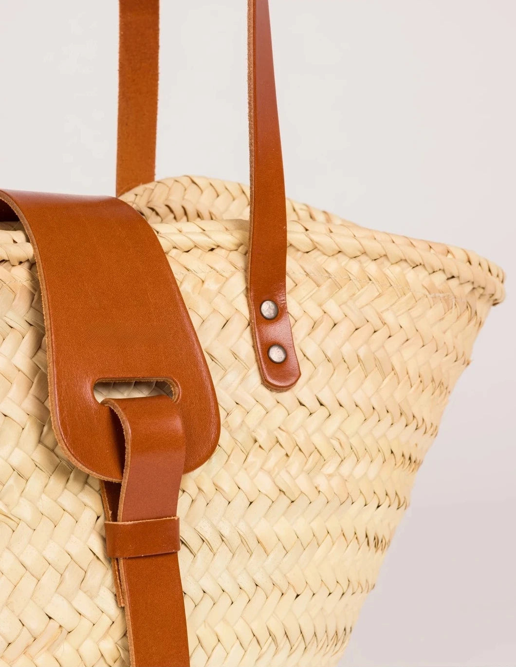 Close-up of the light brown calfskin front strap and trim on the Fadma Small