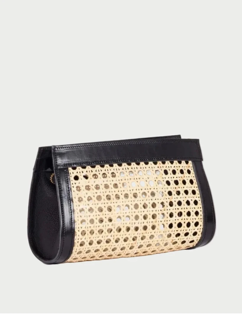 Lamia rattan cane clutch with black leather trim, three-quarter angle