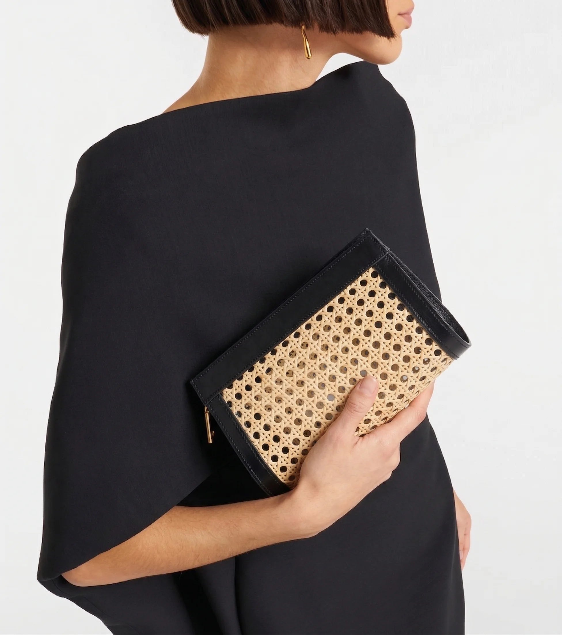  Lamia Cane Clutch carried as a clutch, shown with a black dress