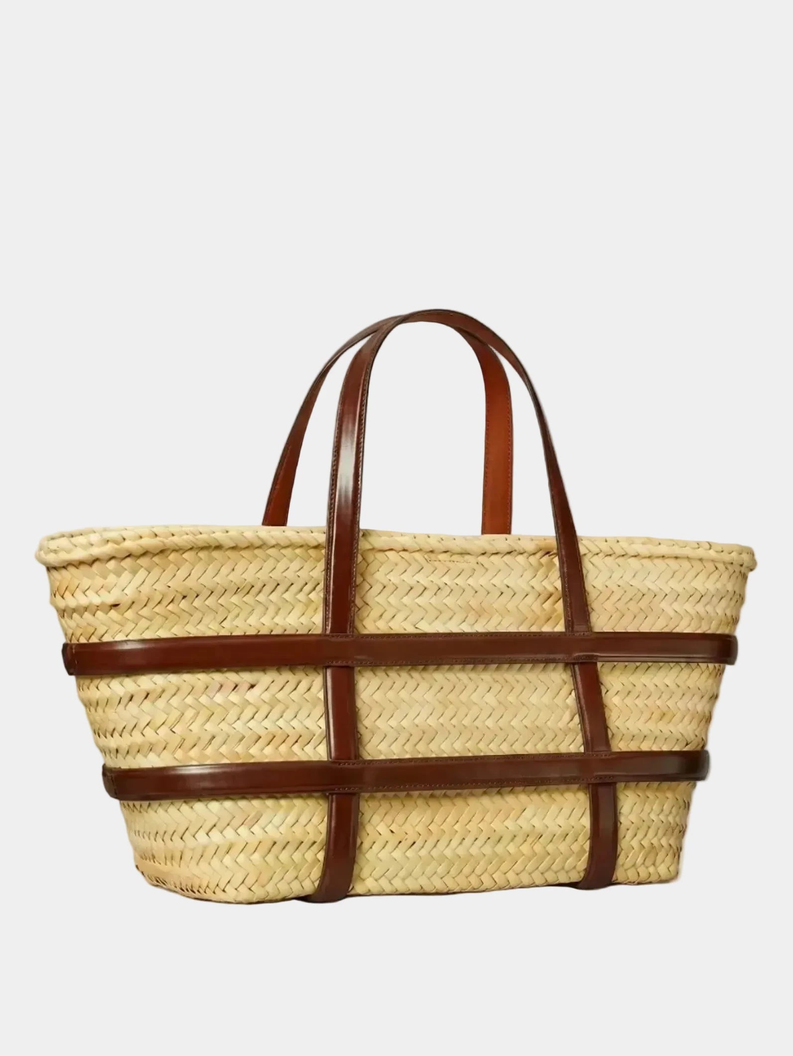 Malika basket tote in dark brown leather, three-quarter angle view showing structured silhouette