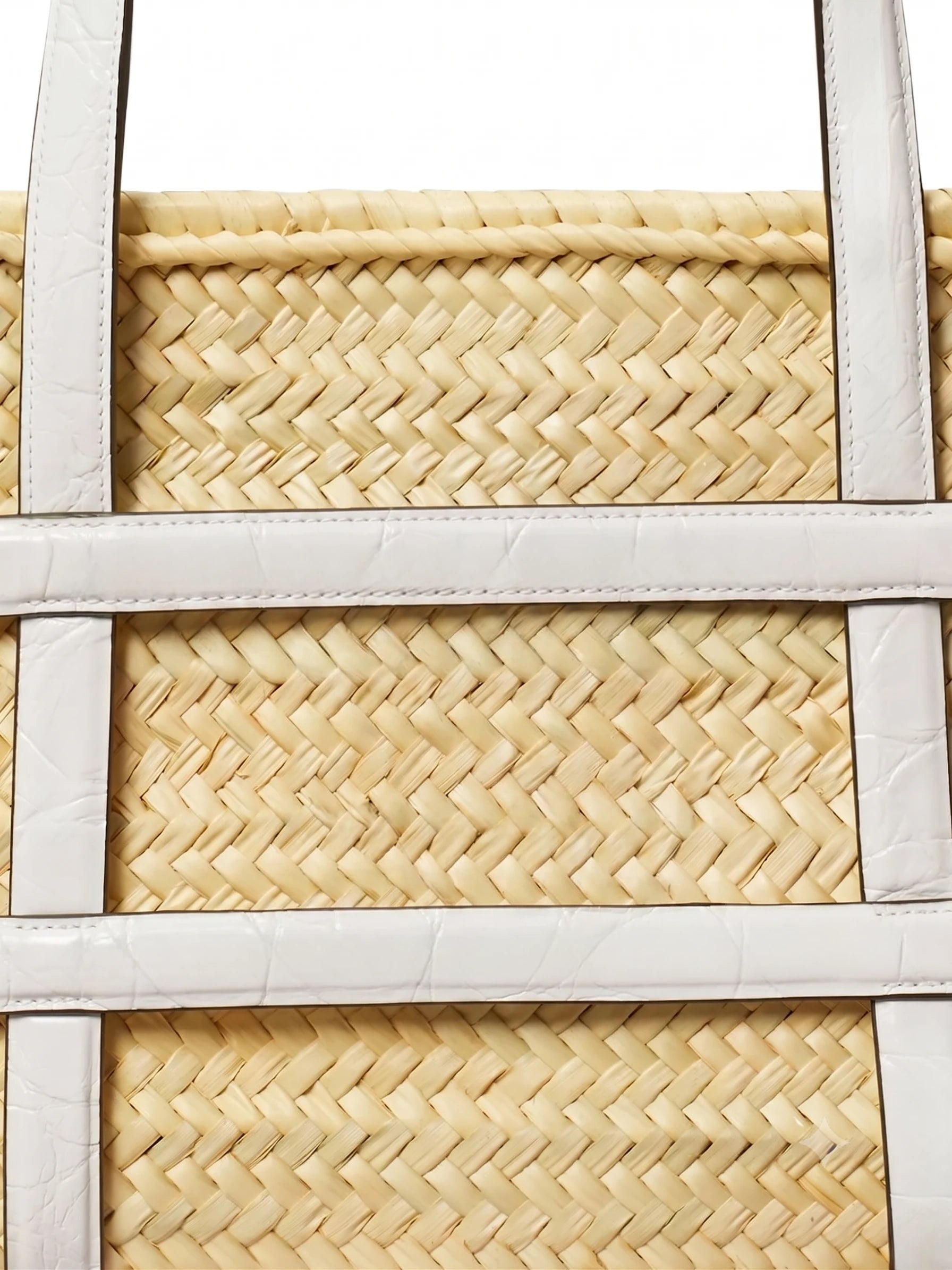 Close-up of herringbone palm weave and white leather straps on Malika basket tote