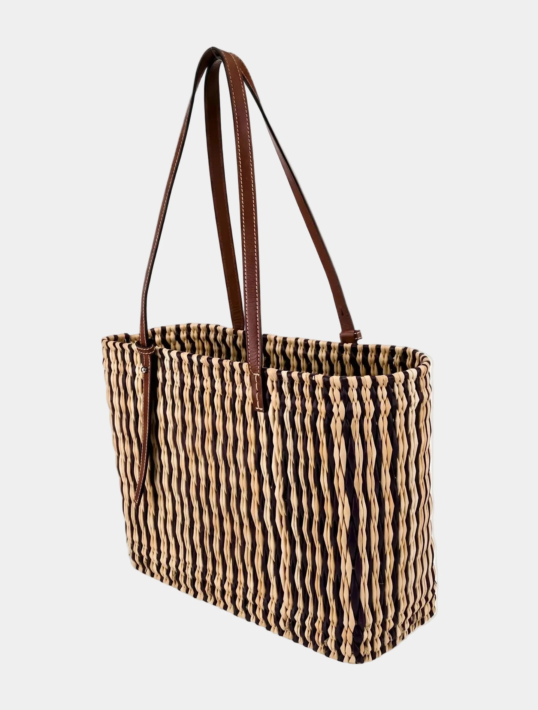 Hand-woven dark brown striped basket tote shown at a three-quarter angle