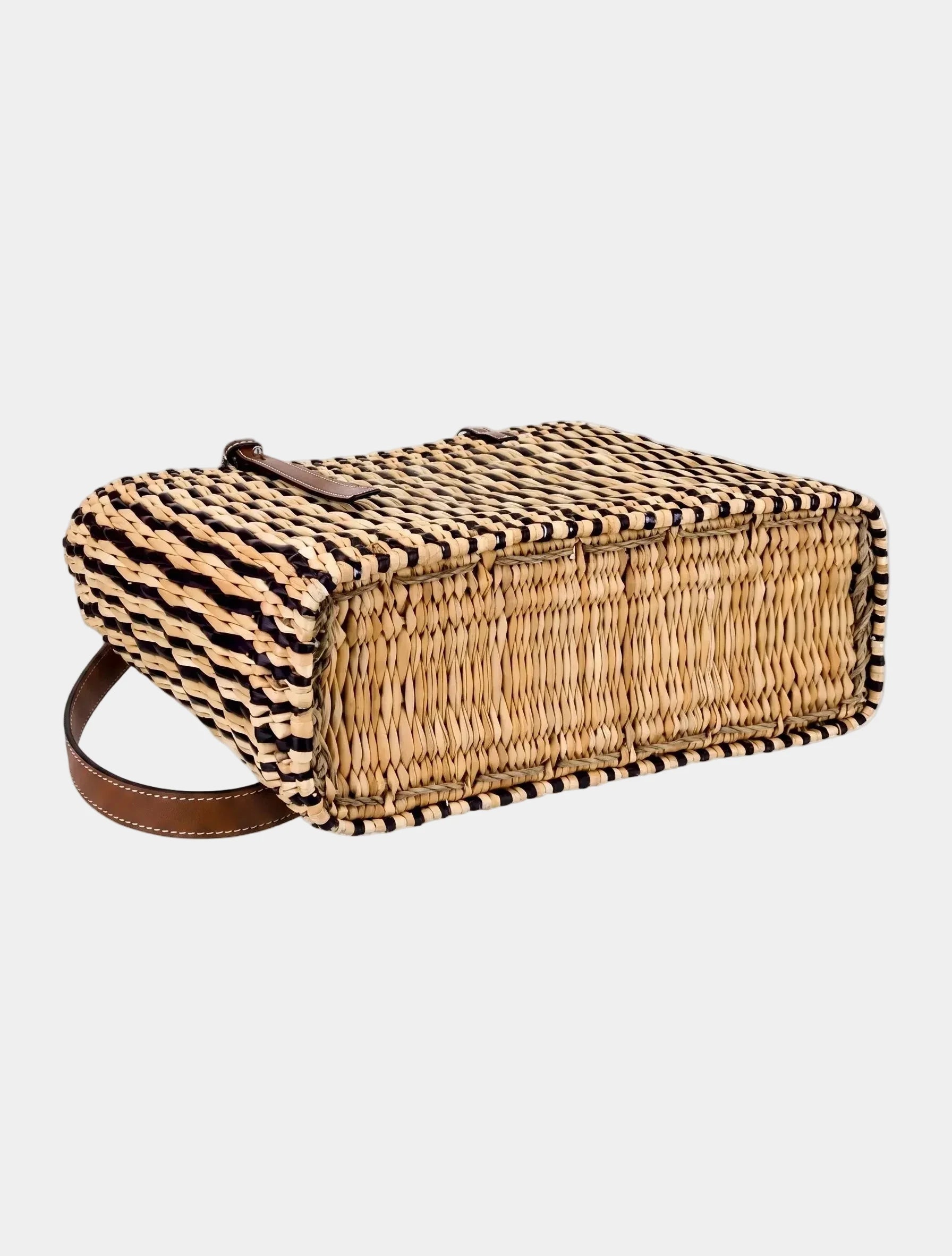 Side view of dark brown striped woven basket tote showing structured shape