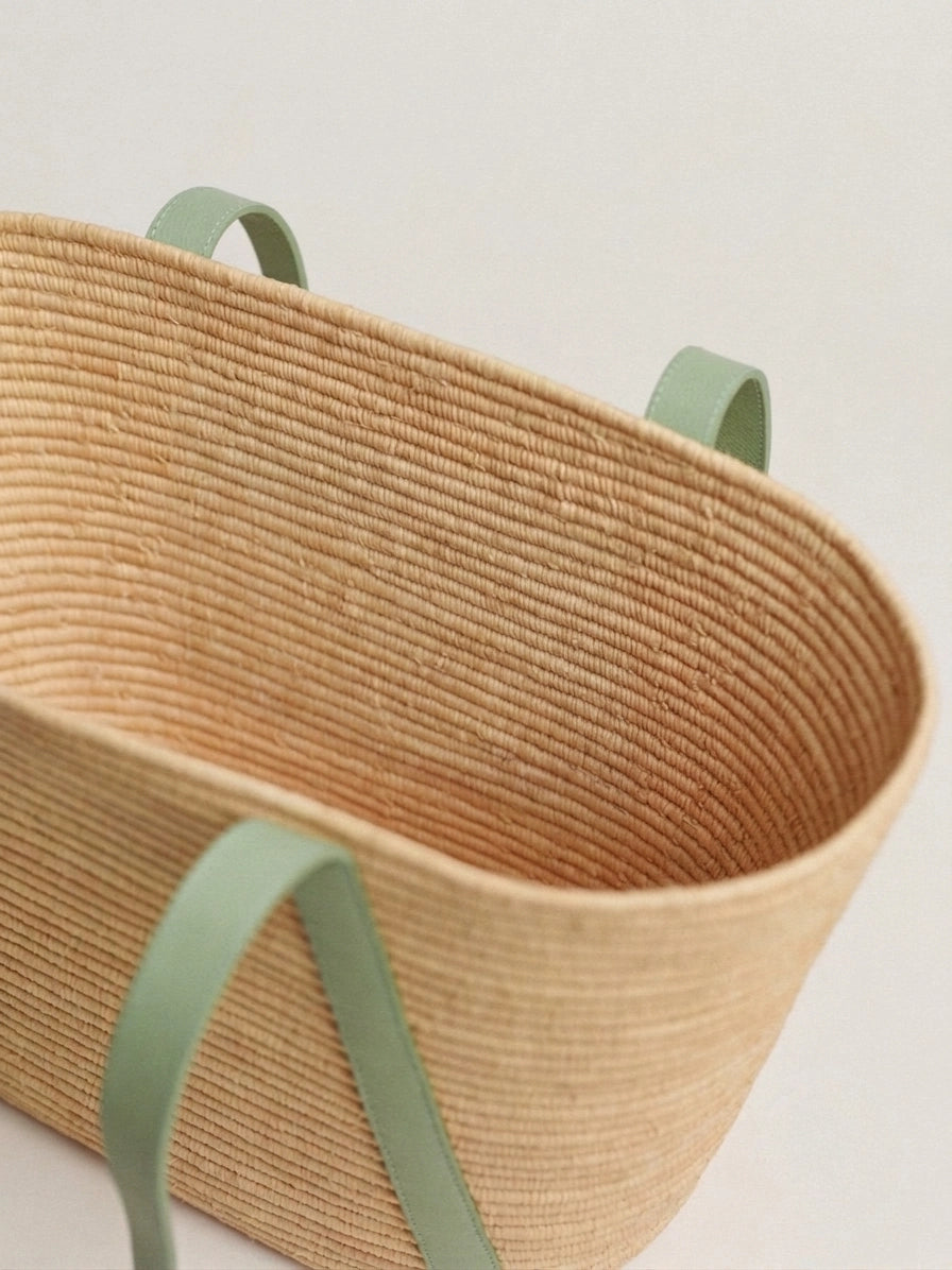 Close view of the Kenza basket tote coiled raffia weave and sage strap detail