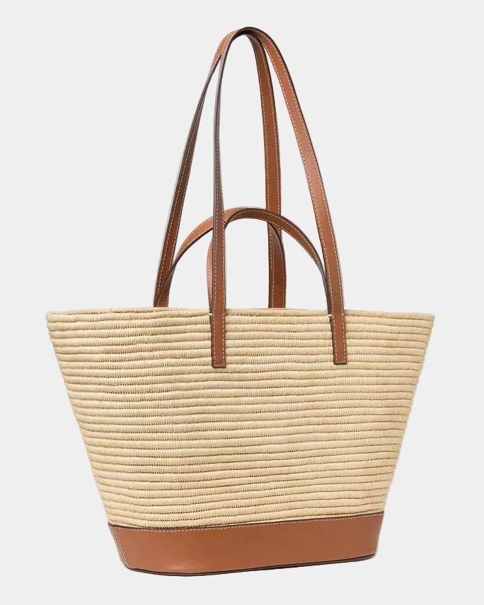 Handwoven raffia basket tote with cognac leather straps raised, front view