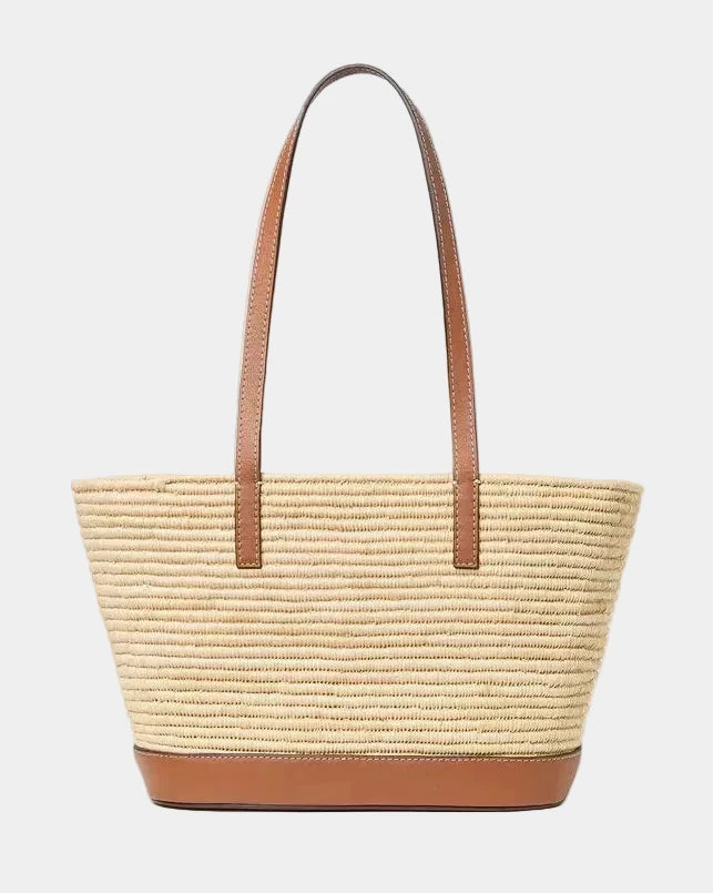 Natural raffia basket tote with cognac leather trim, straps, and base, front view