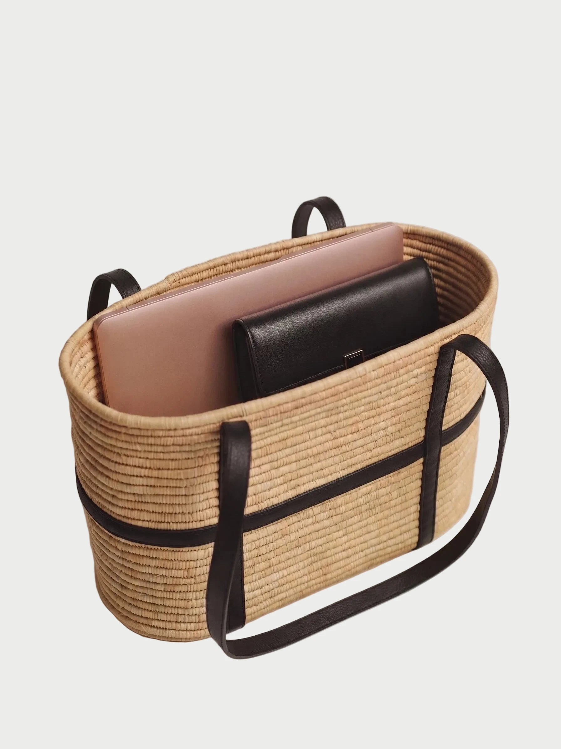 terior of Kenza raffia tote showing leather pocket and open unlined basket weave