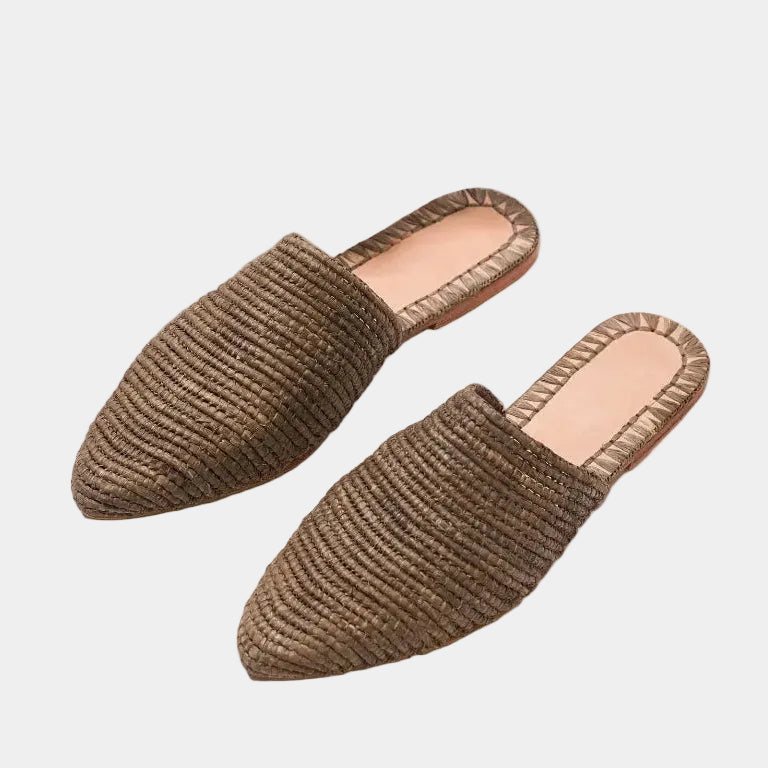  tobacco brown raffia babouche mules with palm leaf shadow, styled flat lay — Tilila in tobacco by MARRAVIE