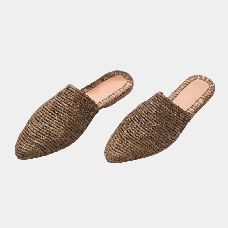 Pair of tobacco raffia babouche mules with pointed toe on white background — Tilila mule by MARRAVIE