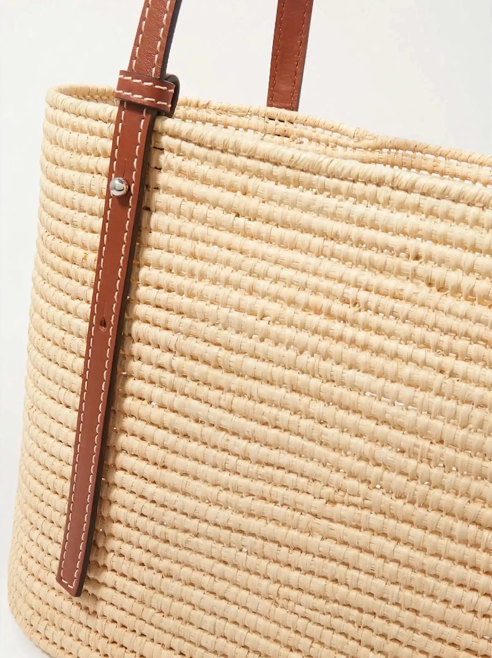 Brown raffia Yasmine Tote with calfskin straps, three-quarter angle