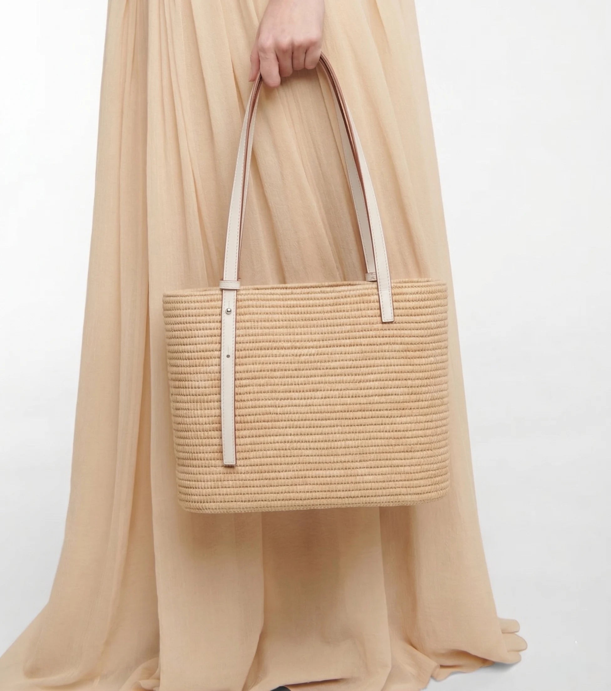 Model carrying the white Yasmine Raffia Tote, full-length