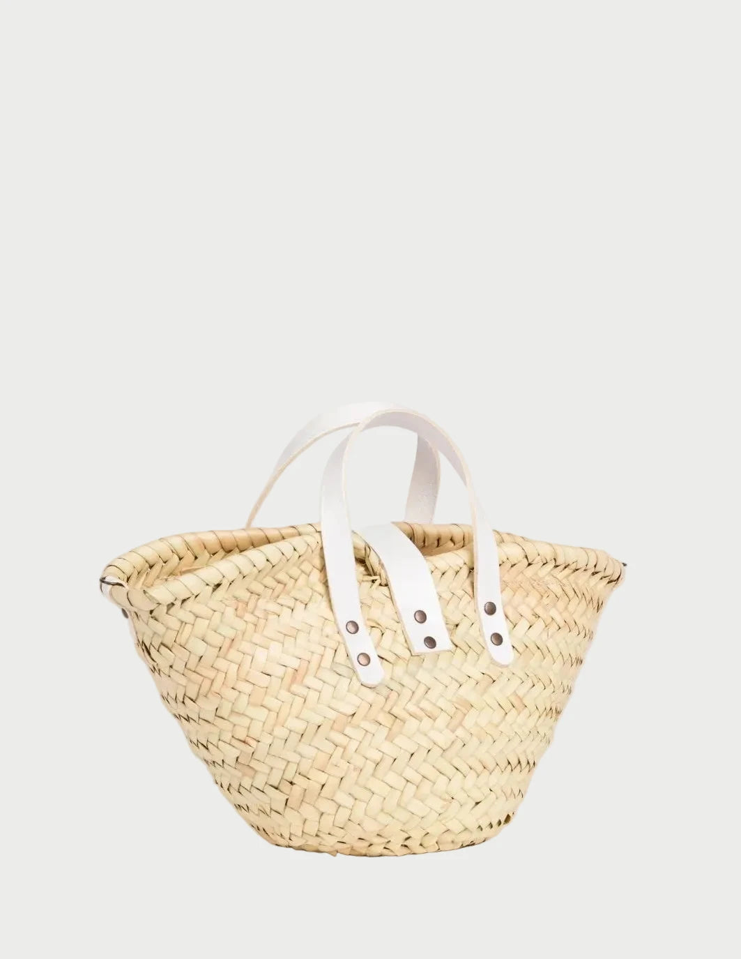 Back view of the Zahira Mini palm leaf basket bag showing the woven doum palm and white handles