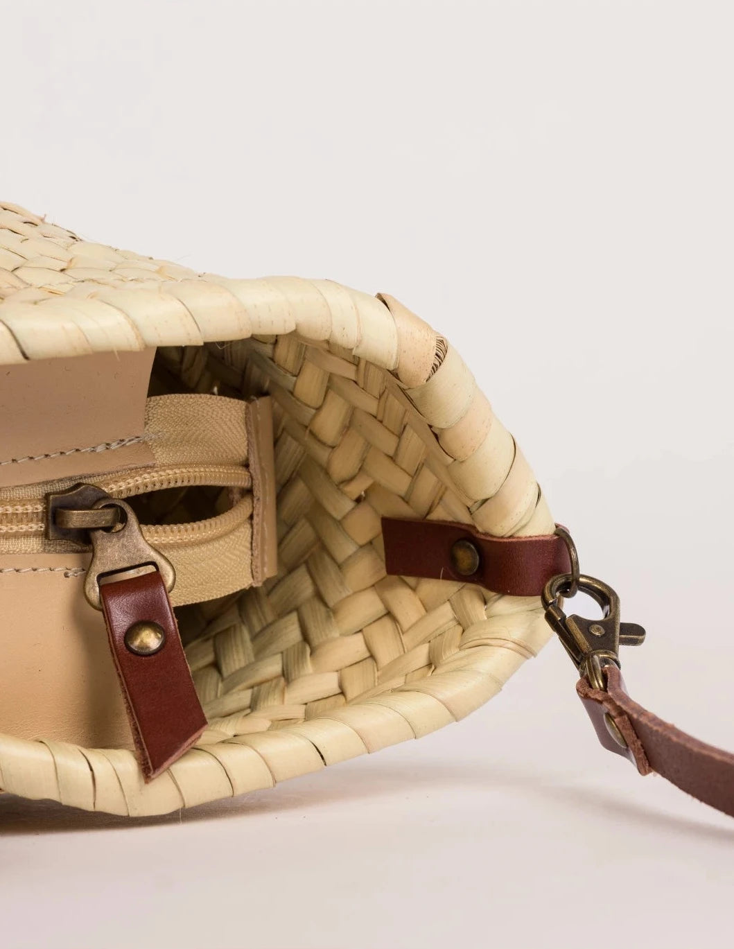 Zahira Mini handwoven palm leaf basket bag with dark brown calfskin shoulder strap and zip 