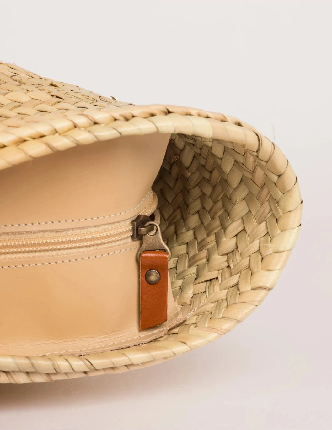 inside view of the Zhour Large basket bag in palm leaf with dark brown calfskin straps
