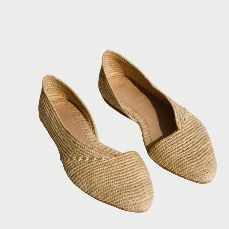 Zineb handwoven raffia flats in natural beige, two pairs in sunlight